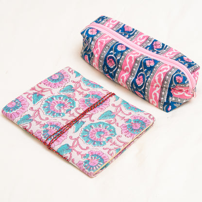 A hand block printed journal and a cotton travel pouch in pink and blue patterns on a white background