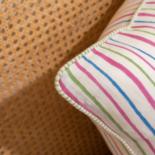 Close-up of a fabric with colorful stripes on a textured brown background