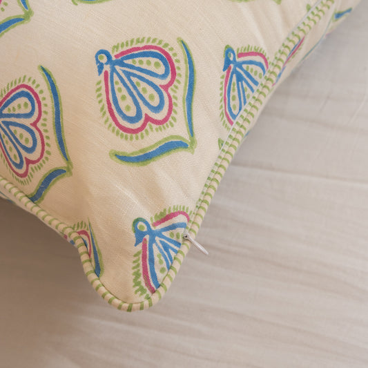 Hand block printed linen pillow cover with delicate bird print in soft blue, green and pink  natural dyes, on a neutral background