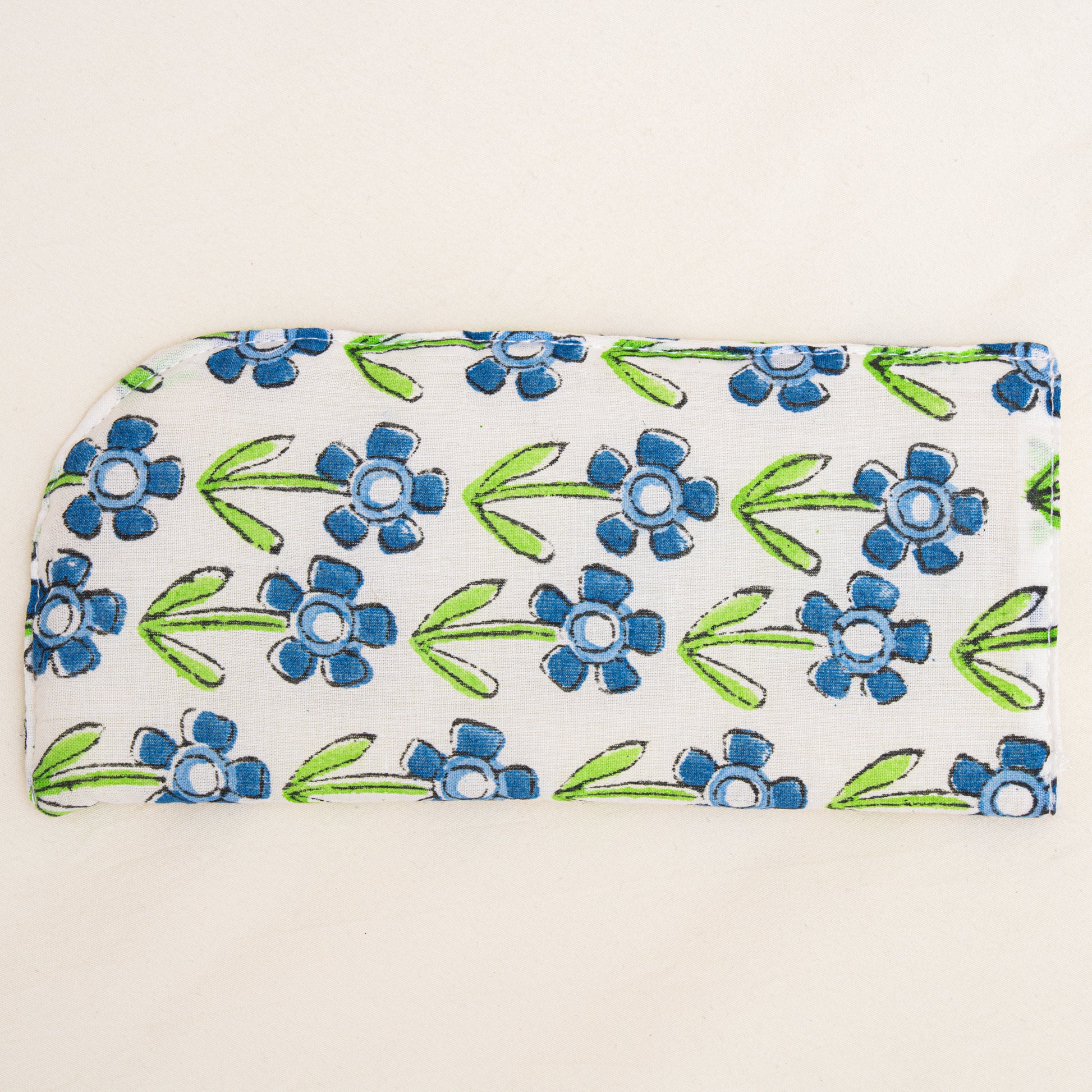 Floral patterned hand block printed pouch with blue flowers and green leaves on a white background