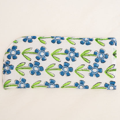 Floral patterned hand block printed pouch with blue flowers and green leaves on a white background