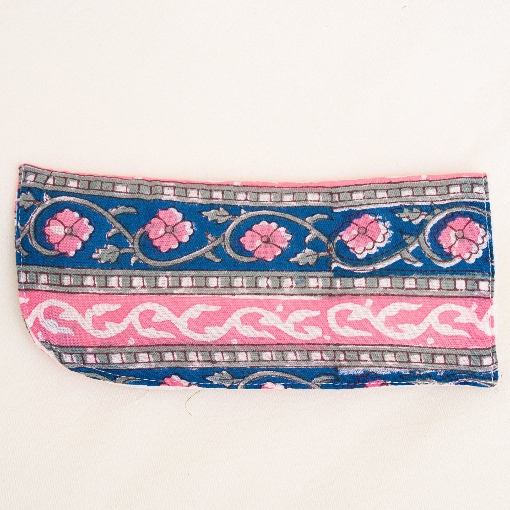 Decorative cotton hand block printed pouch with floral and geometric patterns on a white background