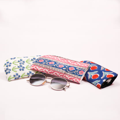 Colorful hand block printed  pouches with sunglasses on a white background