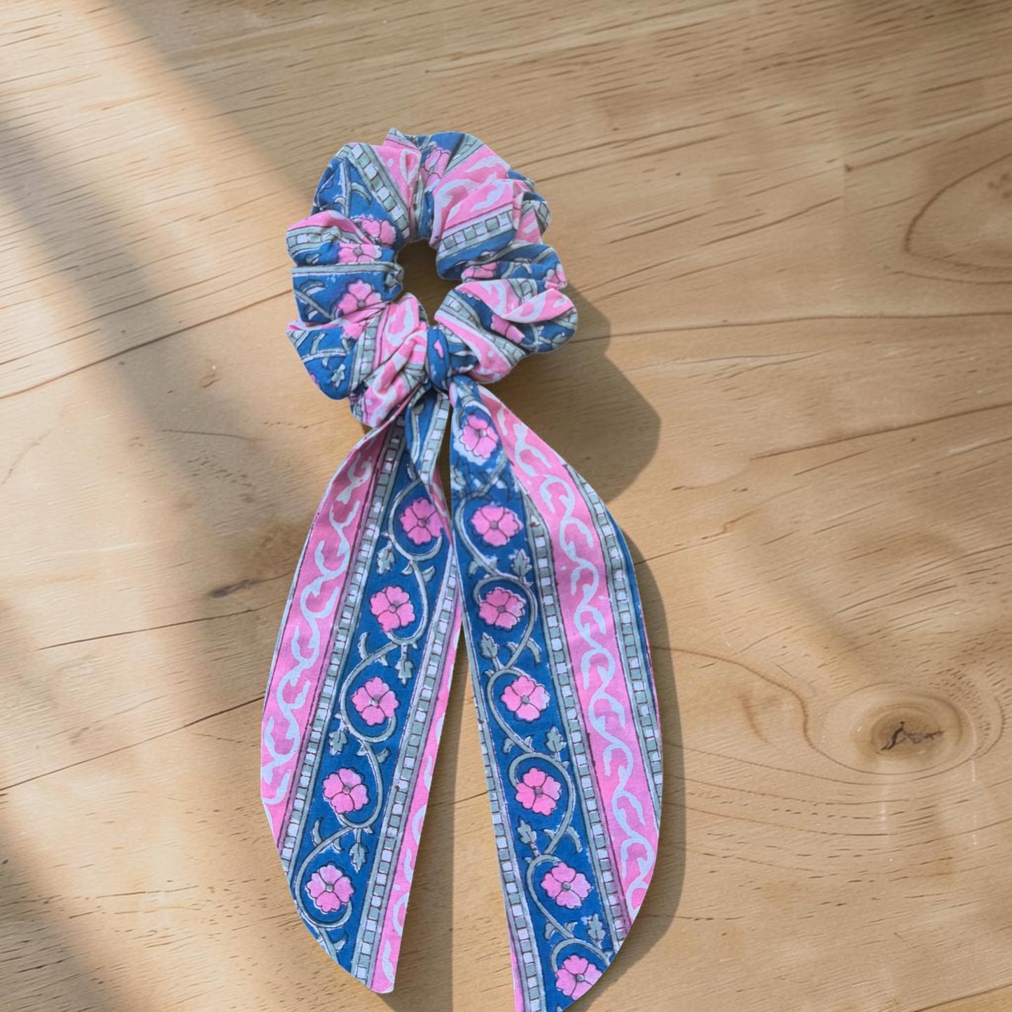 Cotton Hand Block Printed Patterned scrunchie in pink and blue color on a wooden surface
