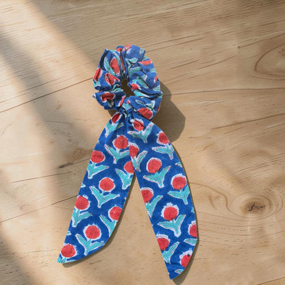 Cotton Hand Block Printed Blue scrunchie with red and green floral pattern on a wooden surface