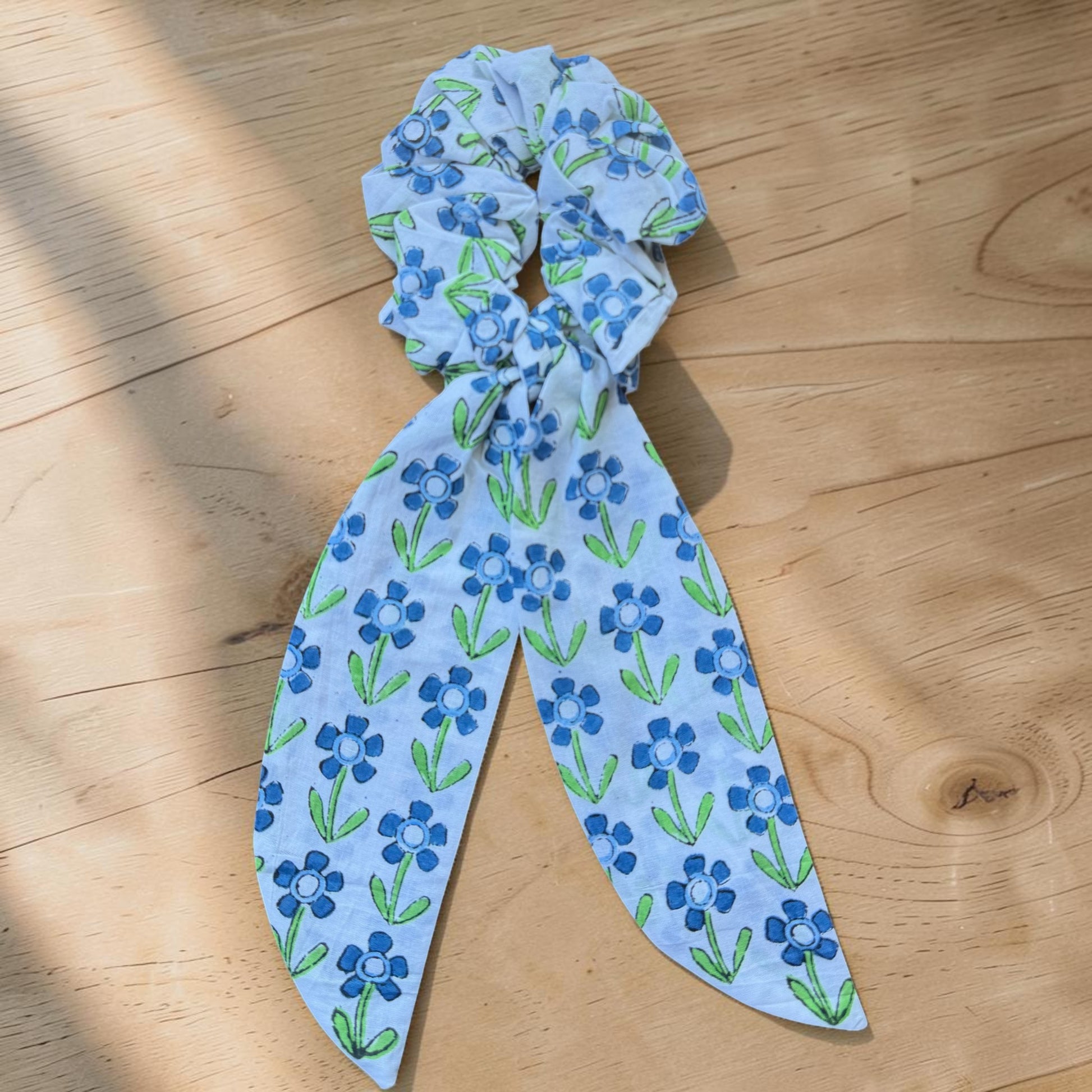 Cotton hand block printed Blue floral patterned bow on a wooden surface