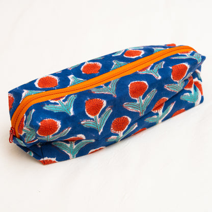 Cotton hand block printed Floral-patterned travel pouch with orange zipper on a white background