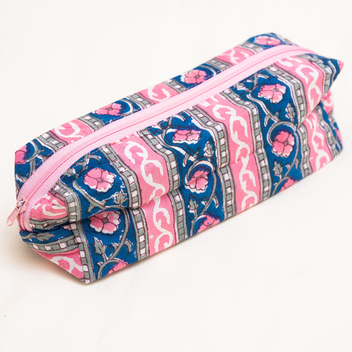 Cotton Travel Pouch with hand block printed pink and blue floral pattern on a white background