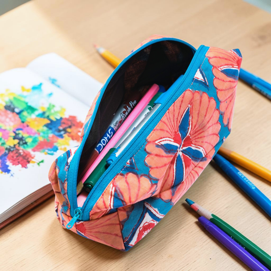 Cotton Hand Block Printed Floral-patterned Travel pouch with stationery on a wooden surface